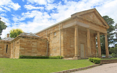 Fototapeta na wymiar Historic sandstone Berrima Courthouse. Built in the Regency Style. The facade consists of four Doric columns with classic Greek bases and capitals