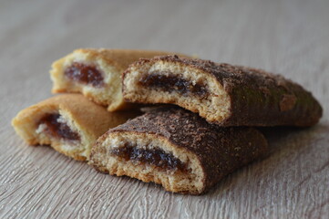 homemade mini strudels stuffed with cherry jam on a wooden background
