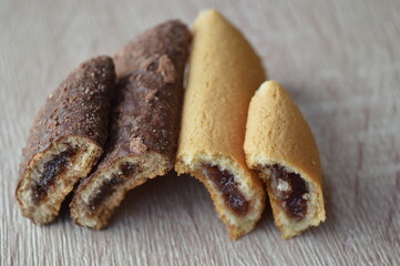 homemade mini strudels stuffed with cherry jam on a wooden background