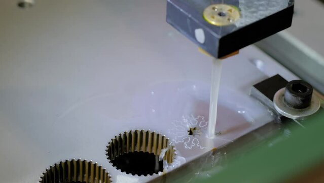 Automatic cnc wire cutting machine working with metal workpiece with sparks at factory, plant. Metalworking, industrial, machining, technology, manufacturing, equipment concept