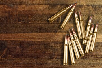 gun bullets on wooden surface background