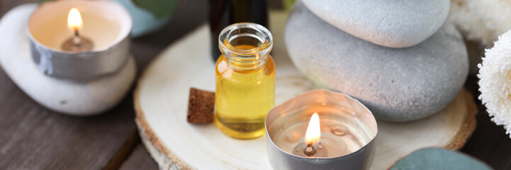 Assortment of natural oils in glass bottles on wooden background. Concept of pure organic ingredients in cosmetology. Bath accessories, atmosphere of harmony, relax. Banner. Healthy lifestyle