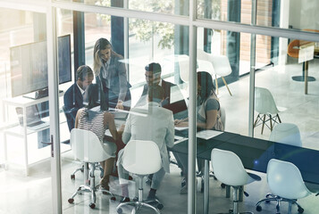 Presenting ideas to the team. Shot of corporate businesspeople meeting in the boardroom.