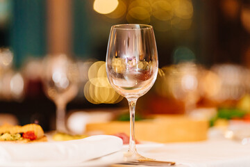 an empty wine glass on the festive table. tableware for restaurants and at home.