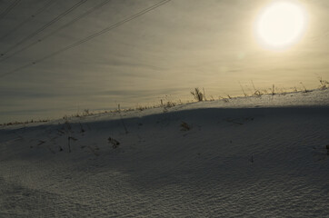 Fototapeta na wymiar Sun Shining over a Dune of Snow