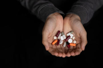 Two hands holding pills. Medicine for depression, fever, stomach pain.