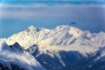Fototapeta na wymiar Austrian Alps mountain peaks covered with snow during winter time.