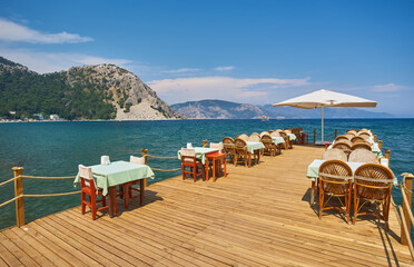 Beach cafe at dawn. Empty tables in a cafe, a sunny morning on the beach.