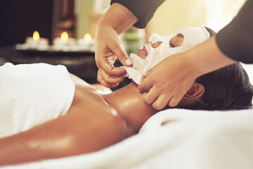 Let the beautification begin. Shot of a young woman receiving a beauty treatment with a mask at a spa.