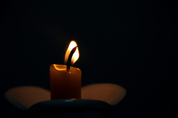 burning candle in the dark 