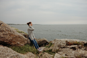 beautiful woman freedom walk on the stone coast female relaxing