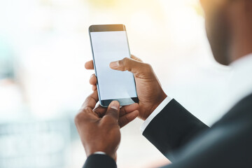 Hes mobile, but always in reach. Closeup shot of an unrecognizable businessman using a cellphone in an office.