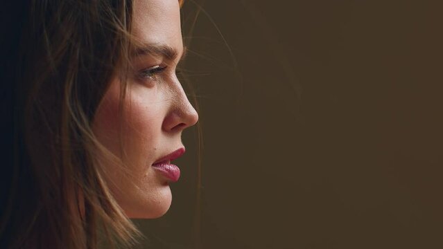 Closeup profile of beautiful young girl with waving hairs. Natural beauty, haircare, skincare cosmetics ad. Prores codec