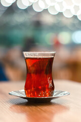 a glass of turkish black tea on wooden table