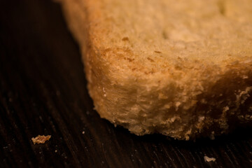 Close up of toast texture on a black wooden table 