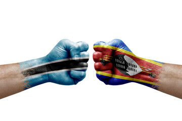 Two hands punch to each others on white background. Country flags painted fists, conflict crisis concept between botswana and eswatini