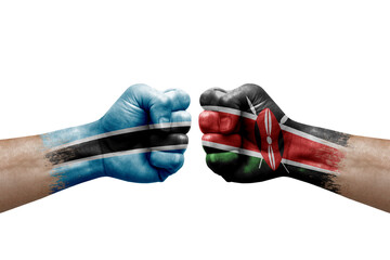 Two hands punch to each others on white background. Country flags painted fists, conflict crisis concept between botswana and kenya