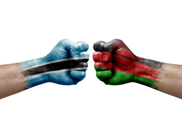 Two hands punch to each others on white background. Country flags painted fists, conflict crisis concept between botswana and malawi