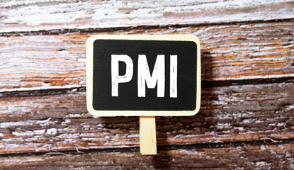 PMI - acronym from wooden blocks with letters, abbreviation PMI Private Mortgage Insurance, Purchasing Managers Index.