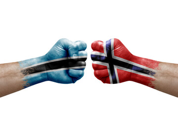 Two hands punch to each others on white background. Country flags painted fists, conflict crisis concept between botswana and norway