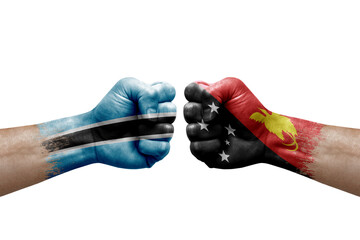 Two hands punch to each others on white background. Country flags painted fists, conflict crisis concept between botswana and papua new guinea
