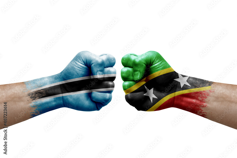 Wall mural Two hands punch to each others on white background. Country flags painted fists, conflict crisis concept between botswana and saint kitts and nevis