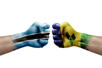 Two hands punch to each others on white background. Country flags painted fists, conflict crisis concept between botswana and saint vincent and the grenadines - obrazy, fototapety, plakaty