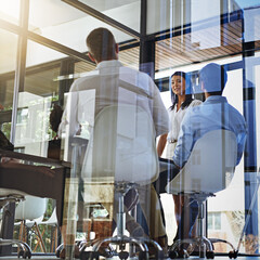 Meeting behind class walls. Shot of a group of young woman giving a presentation to colleagues in a boardroom.