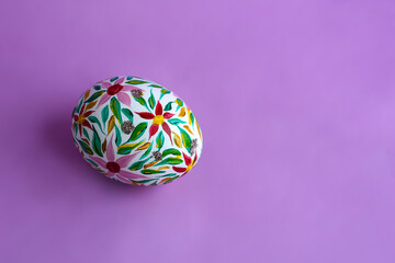 easter egg with a floral pattern on a purple background. place for text