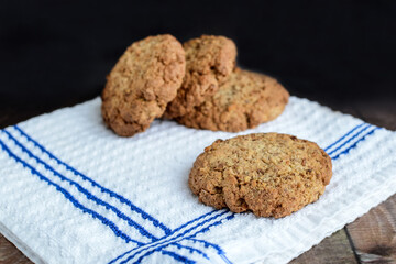 oatmeal cookies on a white towel on a dark rustic background. confectionery.