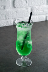 Green fruit flavor drinks with soda water in glass