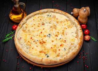 Pizza Quattro Formaggi Four Cheese Pizza on Wooden Surface.