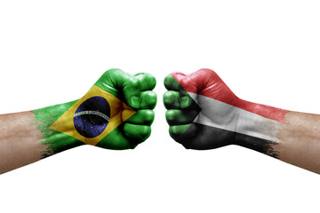 Two hands punch to each others on white background. Country flags painted fists, conflict crisis...