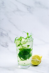 cold detox drink with cucumber, mint, lime and pea sprouts