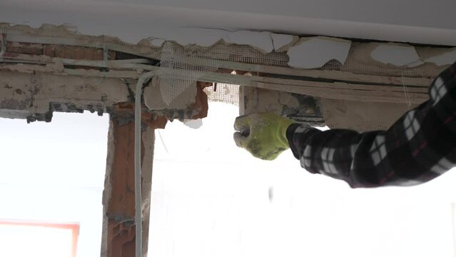 Man trying to remove a lintel during apartment remodeling