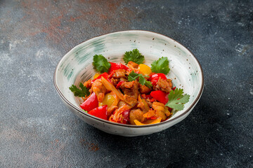 Pork in sweet and sour sauce with fried vegetables on plate
