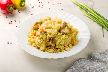 pilaf with chicken on white marble table