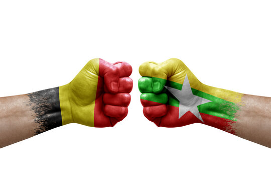 Two hands punch to each others on white background. Country flags painted fists, conflict crisis concept between belgium and myanmar - Powered by Adobe