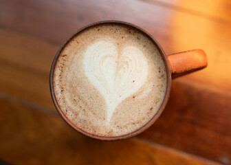 cup of coffee or hot chocolate on the wooden background in cafe