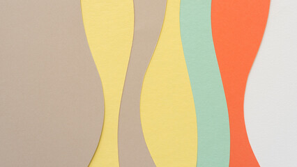 paper design suitable as a background with blank space featuring undulating lines in beige, yellow, green, and orange
