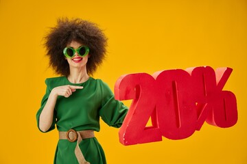 Beauty Fashion woman green dress afro hairstyle dark glasses twenty percent in hands color background unaltered