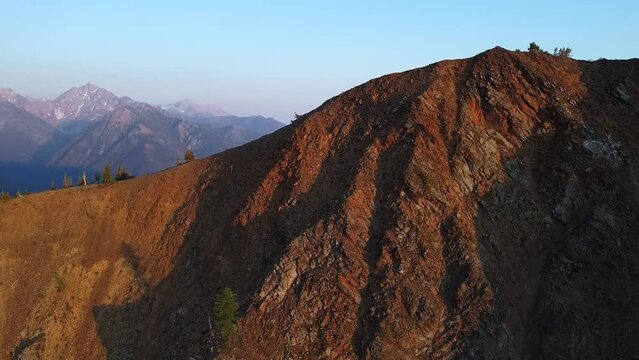 Orbiting around the mountain in South Rockies, BC, sunset aerial shot