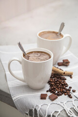white porcelain coffee cup mugs handle with hot drink and coffee beans