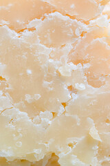 Background of natural farm parmesan. Texture of homemade goat cheese