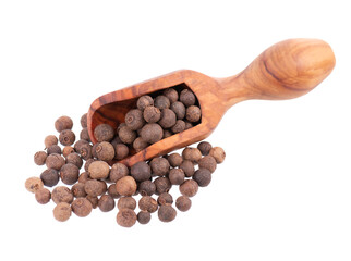 Allspice in wooden scoop, isolated on white background. Jamaican pepper, pimento berry, allspice peppercorns or myrtle pepper.