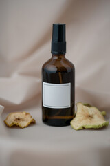 A bottle for essential oils, perfumes with a decoration of dried apples