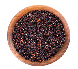 Black quinoa seeds in wooden bowl, isolated on white background. Pile of raw kinwa. Top view.