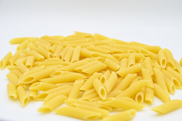 Raw penne rigate pasta, isolated on a white background
