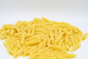 Raw penne rigate pasta, isolated on a white background
