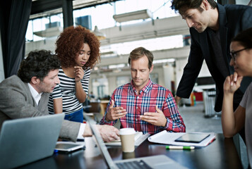 Designing minds. Shot of office workers talking in a meeting in an office.
